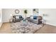 Comfortable living room with plush seating, decorative rug, and modern accents at 737 E 7Th Pl, Mesa, AZ 85203