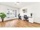 Bright home office with wood floors, white walls, and modern desks near the window at 737 E 7Th Pl, Mesa, AZ 85203