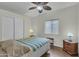 Well-lit bedroom with closet, side table with lamp, and a ceiling fan at 900 W Broadway Ave # 45, Apache Junction, AZ 85120