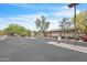 A gated community entrance with mature landscaping and a well-maintained road at 900 W Broadway Ave # 45, Apache Junction, AZ 85120