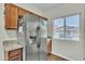 A stainless steel refrigerator stands against the wall next to a window with blinds at 900 W Broadway Ave # 45, Apache Junction, AZ 85120