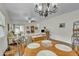An open concept living room and dining room share hardwood floors and natural light at 900 W Broadway Ave # 45, Apache Junction, AZ 85120