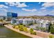 Scenic aerial view of white apartment buildings with a sparkling blue pool and Tempe Town Lake views at 945 E Playa Del Norte Dr # 3002, Tempe, AZ 85288