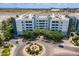 Aerial view shows a landscaped roundabout in front of well-maintained apartment buildings near Tempe Town Lake at 945 E Playa Del Norte Dr # 3002, Tempe, AZ 85288