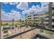 Balcony view of a landscaped courtyard with palm trees and partial view of a community pool and lake at 945 E Playa Del Norte Dr # 3002, Tempe, AZ 85288