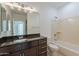 Bathroom featuring single sink vanity with granite countertops and tub with shower at 945 E Playa Del Norte Dr # 3002, Tempe, AZ 85288