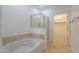 Clean bathroom showcasing a soaking tub with tile accents and a glass-enclosed shower at 945 E Playa Del Norte Dr # 3002, Tempe, AZ 85288