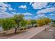 Exterior view of a walking path, trees, and shrubs beside Tempe Town Lake on a bright and sunny day at 945 E Playa Del Norte Dr # 3002, Tempe, AZ 85288