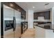 A kitchen featuring stainless steel appliances, dark cabinets, tile floors, and a kitchen island at 945 E Playa Del Norte Dr # 3002, Tempe, AZ 85288