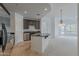 This kitchen features stainless steel appliances, tile floors, and an island overlooking the living area at 945 E Playa Del Norte Dr # 3002, Tempe, AZ 85288
