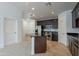 A kitchen featuring stainless steel appliances, dark cabinets, tile floors, and a kitchen island at 945 E Playa Del Norte Dr # 3002, Tempe, AZ 85288