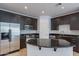 This kitchen features stainless steel appliances, dark cabinets, tile floors, and an island at 945 E Playa Del Norte Dr # 3002, Tempe, AZ 85288