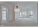 A living room with a ceiling fan, a modern light fixture, and a patio door with a view at 945 E Playa Del Norte Dr # 3002, Tempe, AZ 85288