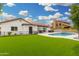 Well-manicured lawn complements this home with a pool, covered patio, and landscaped surroundings at 102 S Honeysuckle Ln, Gilbert, AZ 85296