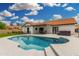 Expansive backyard features a pool, covered patio, and a meticulously maintained lawn for outdoor enjoyment at 102 S Honeysuckle Ln, Gilbert, AZ 85296