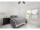 This is a cozy bedroom featuring a ceiling fan, an exterior window, and modern flooring at 102 S Honeysuckle Ln, Gilbert, AZ 85296