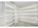 Walk-in closet provides tons of storage, with many shelves on three walls at 102 S Honeysuckle Ln, Gilbert, AZ 85296
