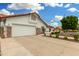 Single-story home with a spacious driveway, two-car garage, and meticulously maintained landscaping at 102 S Honeysuckle Ln, Gilbert, AZ 85296