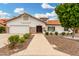 Charming single-story home boasts a well-manicured lawn, mature landscaping, and a welcoming front entrance at 102 S Honeysuckle Ln, Gilbert, AZ 85296
