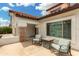 Quaint front porch featuring cozy chairs, a fire pit, and an inviting space for outdoor relaxation at 102 S Honeysuckle Ln, Gilbert, AZ 85296