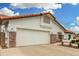 Single-story home boasts a two-car garage, brick accents, and drought-tolerant landscaping at 102 S Honeysuckle Ln, Gilbert, AZ 85296