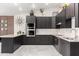 Modern kitchen featuring stainless steel appliances, dark cabinets and white tile backsplash at 102 S Honeysuckle Ln, Gilbert, AZ 85296