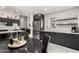 Modern eat-in kitchen featuring stainless steel appliances, dark cabinets and granite countertops at 102 S Honeysuckle Ln, Gilbert, AZ 85296