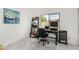 Bright home office features a desk, chair, bookshelf, and a window overlooking the outdoors at 102 S Honeysuckle Ln, Gilbert, AZ 85296