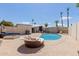 Lounge area with chairs surrounding an in-ground pool, a perfect oasis for relaxation and entertainment at 10472 W Devonshire Ave, Phoenix, AZ 85037