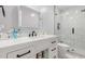 Modern bathroom with white vanity, black fixtures, and tiled shower at 10472 W Devonshire Ave, Phoenix, AZ 85037