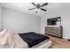 Bedroom featuring a ceiling fan, a modern bed and a large television at 10472 W Devonshire Ave, Phoenix, AZ 85037