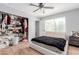 Bedroom features a ceiling fan, a black blanket, and a filled closet at 10472 W Devonshire Ave, Phoenix, AZ 85037