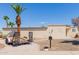 Charming single-story home featuring desert landscaping and mature palm trees for a tranquil outdoor setting at 10472 W Devonshire Ave, Phoenix, AZ 85037