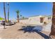 Charming single-story home featuring desert landscaping and mature palm trees for a tranquil outdoor setting at 10472 W Devonshire Ave, Phoenix, AZ 85037