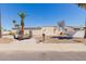 Charming single-story home featuring desert landscaping and mature palm trees for a tranquil outdoor setting at 10472 W Devonshire Ave, Phoenix, AZ 85037