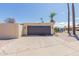 Detached two-car garage with decorative door and mature palm trees at 10472 W Devonshire Ave, Phoenix, AZ 85037