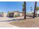 Detached two-car garage with decorative door and mature palm trees at 10472 W Devonshire Ave, Phoenix, AZ 85037