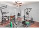Spacious home gym area with weightlifting equipment, machines, and rubber flooring for exercise at 10472 W Devonshire Ave, Phoenix, AZ 85037