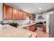 The kitchen features stainless steel appliances, granite countertops, and a range hood at 10472 W Devonshire Ave, Phoenix, AZ 85037