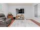 Inviting living room with modern gray color scheme, plush seating and wood flooring at 10472 W Devonshire Ave, Phoenix, AZ 85037