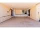 Spacious covered patio with a textured concrete slab floor and neutral paint at 10472 W Devonshire Ave, Phoenix, AZ 85037