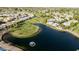 Stunning aerial view showcases homes nestled around a lush golf course and serene lake community at 1134 S 79Th Pl, Mesa, AZ 85208