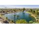 Scenic view of the lake and surrounding community, complete with palm trees and a tranquil fountain at 1134 S 79Th Pl, Mesa, AZ 85208
