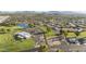 Panoramic aerial view of a community with a lake, golf course, and mountain views at 1134 S 79Th Pl, Mesa, AZ 85208
