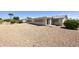 Expansive gravel backyard featuring a covered patio and convenient access to the house at 1134 S 79Th Pl, Mesa, AZ 85208