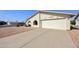 Charming home exterior with a two-car garage, low-maintenance landscaping, and clean curb appeal at 1134 S 79Th Pl, Mesa, AZ 85208