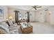 Inviting living room featuring neutral tones, a ceiling fan, and a large window for natural light at 1134 S 79Th Pl, Mesa, AZ 85208