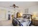 Comfortable primary bedroom with soft carpet, ceiling fan, and ample closet space at 1134 S 79Th Pl, Mesa, AZ 85208