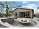 Backyard with desert landscaping, firepit with built-in seating, and covered patio at 11623 W Marguerite Ave, Avondale, AZ 85323