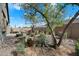 Backyard with desert landscaping, fire pit, and privacy wall creating a tranquil outdoor space at 11623 W Marguerite Ave, Avondale, AZ 85323